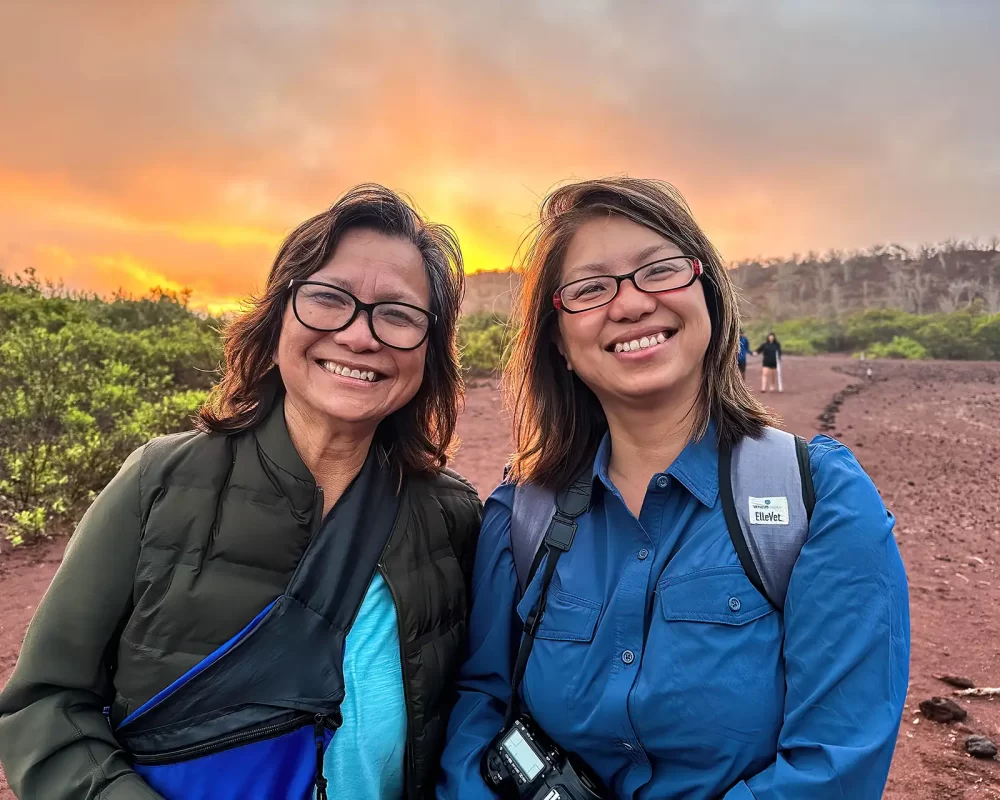 A Filipina and her mother standing at sunrise on Rabida Island in the Galpagos