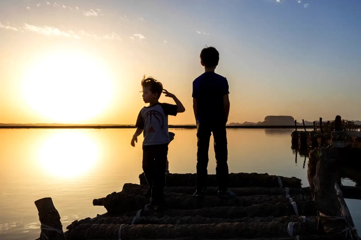 Two kids at sunset at the Siwa Oasis